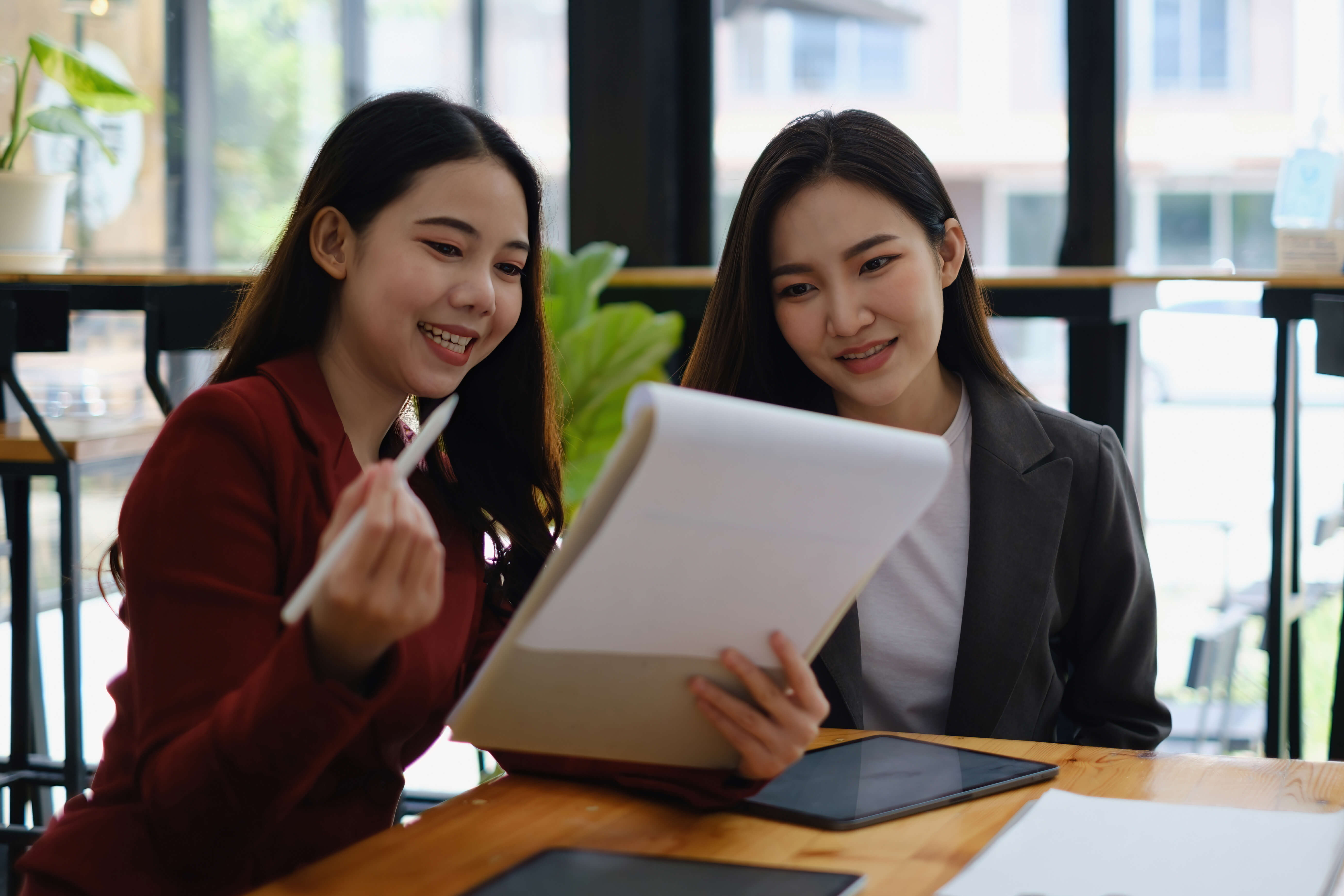 Two digital marketers discusing a pool builder's marketing strategy.