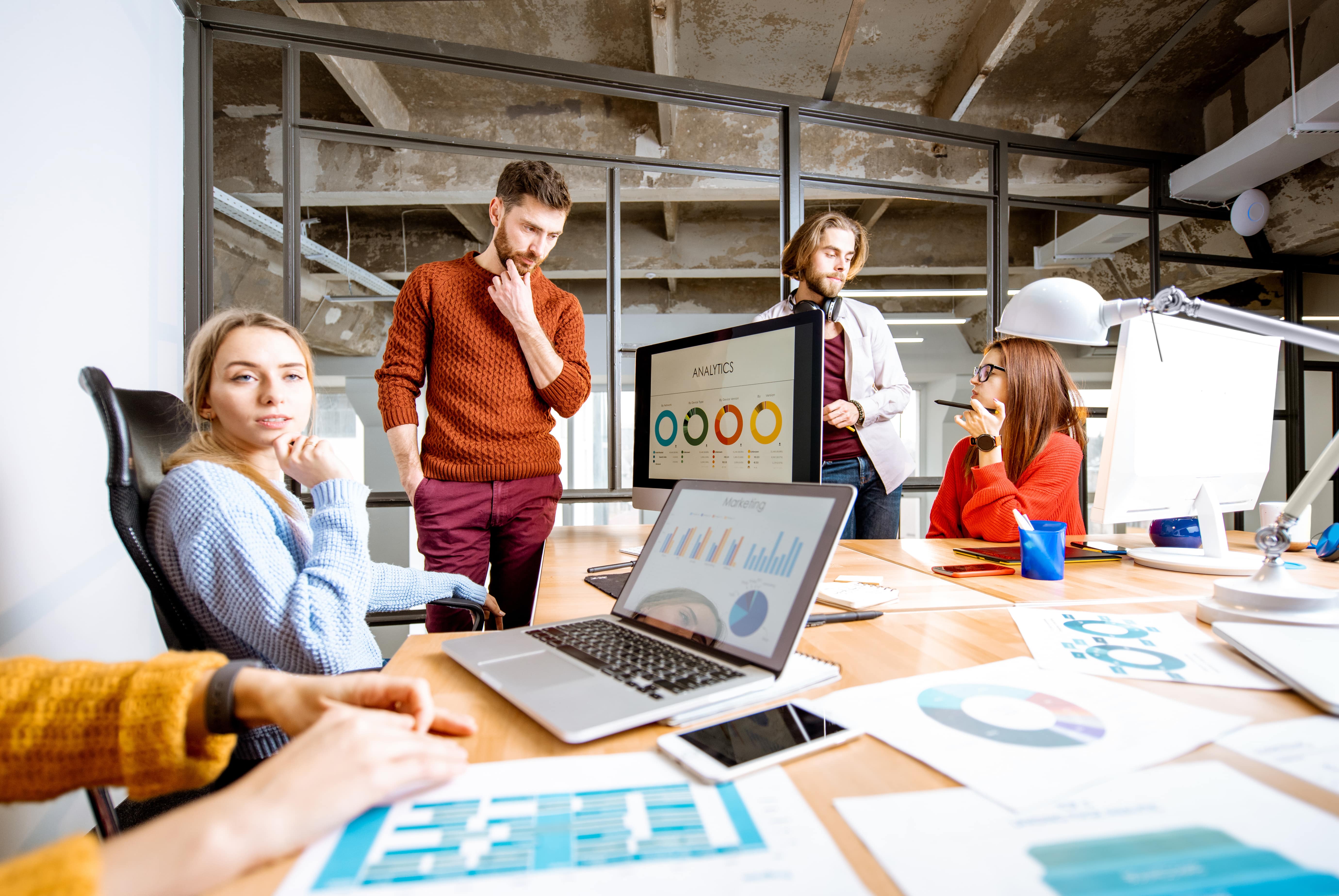 A group of digital marketing specialists analyzing data.